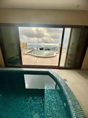 a swimming pool in a house with a view of the ocean at Sunbreeze Delux Vilas in Budva