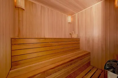 a sauna with wood paneling and a wooden floor at Sunbreeze Delux Vilas in Budva