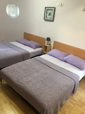 two beds sitting next to each other in a room at Apartmani Milanovic Susanj in Bar