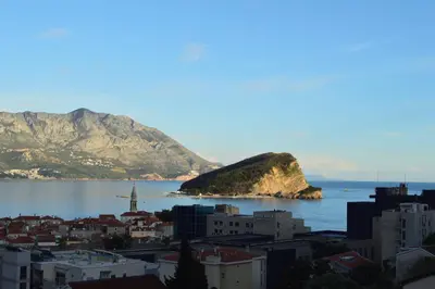 a view of a city and the ocean with a mountain at Vanessa Apartment in Budva