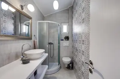 a bathroom with a shower and a sink and a toilet at Sunny Nest Apartments in Kotor