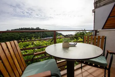 a table and chairs on a balcony with a view at Apartments Ardura in Petrovac na Moru