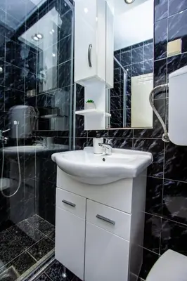 a bathroom with a white sink and a shower at Apartments Ardura in Petrovac na Moru