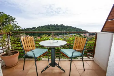 a table and chairs on a balcony with a view at Apartments Ardura in Petrovac na Moru
