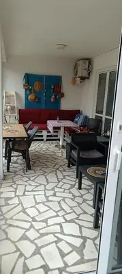 a living room with a red couch and tables at Villa Merci Budva in Budva