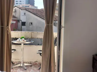 a view of a balcony with a table and a window at Villa Merci Budva in Budva