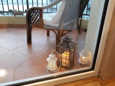 a window with a candle and a chair and a lantern at Seaview Paradise Apartment in Budva