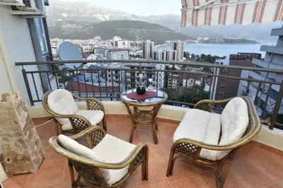 a balcony with chairs and a table with a view at Seaview Paradise Apartment in Budva