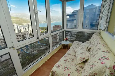 a couch in a room with large windows at Seaview Paradise Apartment in Budva