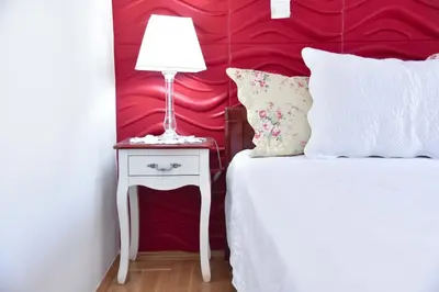 a bedroom with a bed and a table with a lamp at Seaview Paradise Apartment in Budva