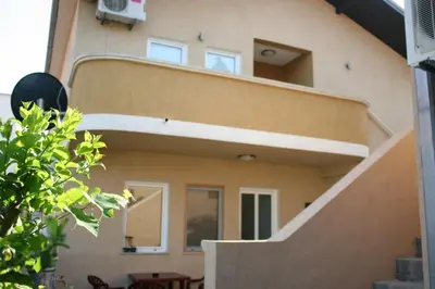 a building with a staircase in front of it at Apartments EMERALD in Ulcinj