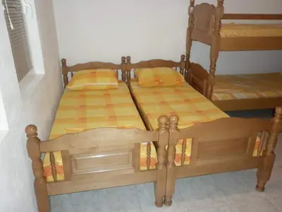 two wooden beds in a room with at Apartments EMERALD in Ulcinj
