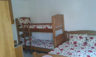 a bedroom with two bunk beds and a bed at Apartments EMERALD in Ulcinj