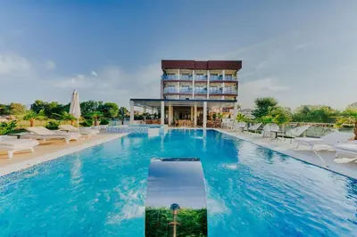 a hotel swimming pool with a building in the background at Hotel Lion in Ulcinj