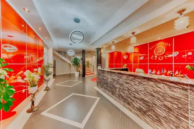 a restaurant with a bar with red walls at Hotel Lion in Ulcinj