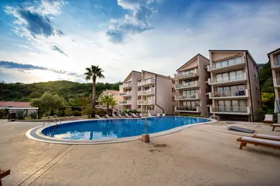 a large apartment complex with a large swimming pool at Charming apartment near beach in Sveti Stefan