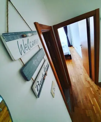 a group of signs on a wall next to a hallway at Charming apartment near beach in Sveti Stefan