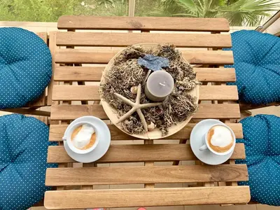 a table with a nest with two cups of coffee at Charming apartment near beach in Sveti Stefan