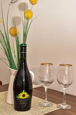 a bottle of wine and two wine glasses on a table at Apartments Simun in Kotor