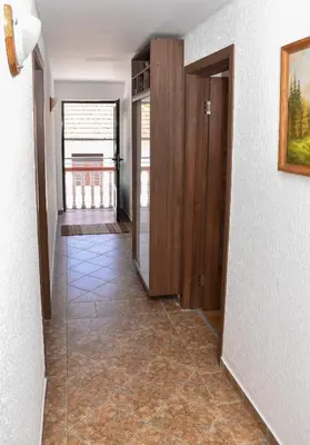 a hallway with a tile floor in a house at Apartments Simun in Kotor