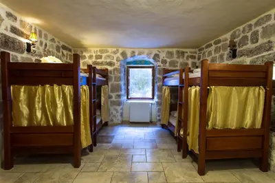 a room with two bunk beds and a window at Old Town Youth Hostel in Kotor