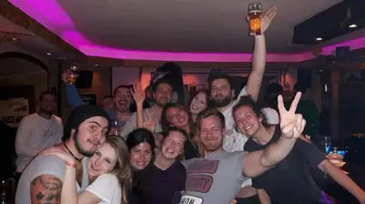 a group of people posing for a picture at a party at Old Town Youth Hostel in Kotor