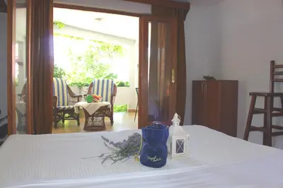 a bedroom with a bed with a table with flowers on it at Monten in Sveti Stefan