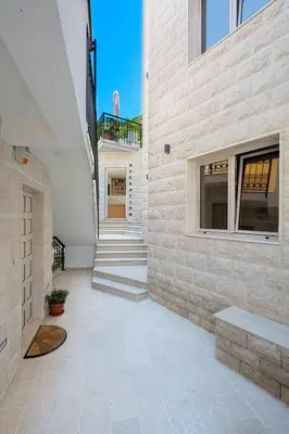 a hallway of a house with a stone wall at Apartments Jovan in Sveti Stefan