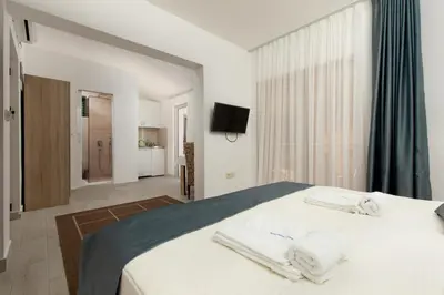 a bedroom with a bed with towels on it at Apartments Jovan in Sveti Stefan