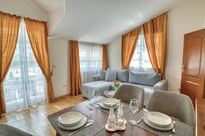 a living room with a table and a couch at Apartments Elena in Budva