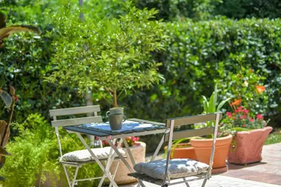 a table and two chairs in a garden at Apartments Elena in Budva