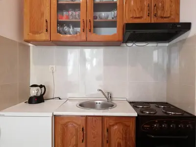 a kitchen with a sink and a stove and cabinets at Apartment Oleander of Budva in Budva