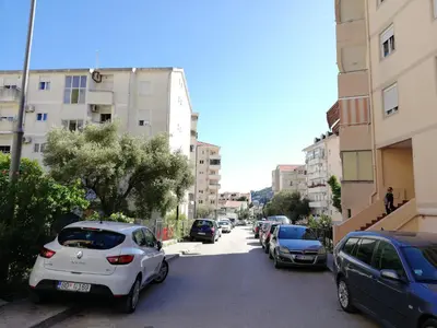 a row of cars parked on a city street at Apartment Oleander of Budva in Budva