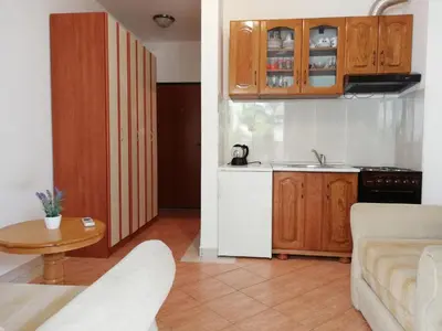 a kitchen and a living room with a table at Apartment Oleander of Budva in Budva