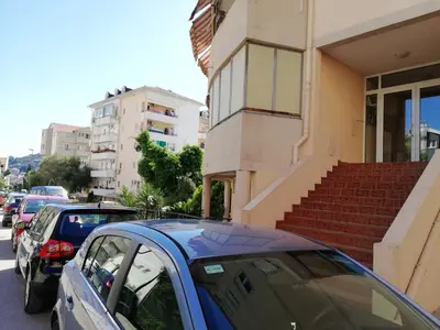 a group of cars parked outside of a building at Apartment Oleander of Budva in Budva