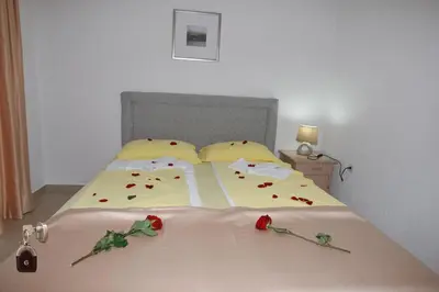a bedroom with a bed with roses on it at Villa Andjelina in Budva