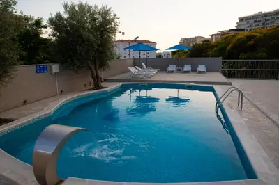 a large swimming pool with blue water at Villa Andjelina in Budva