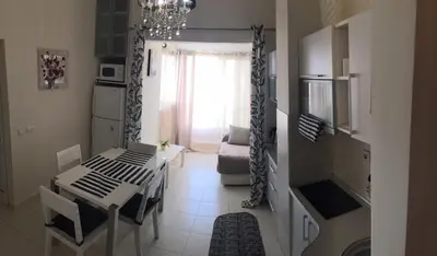 a living room with a table and a dining room at Apartments in Bar city center in Bar