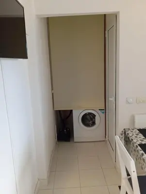 a laundry room with a washer and a washing machine at Apartments in Bar city center in Bar