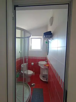 a bathroom with two toilets and a glass shower at Apartments in Bar city center in Bar