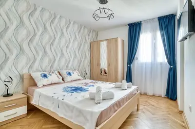 a bedroom with a bed with towels on it at COMFORT APARTMENT NEAR THE BEACH in Budva