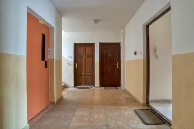 an empty hallway with two doors and a tile floor at COMFORT APARTMENT NEAR THE BEACH in Budva