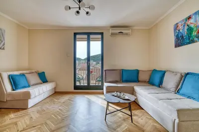 a living room with two couches and a table at COMFORT APARTMENT NEAR THE BEACH in Budva