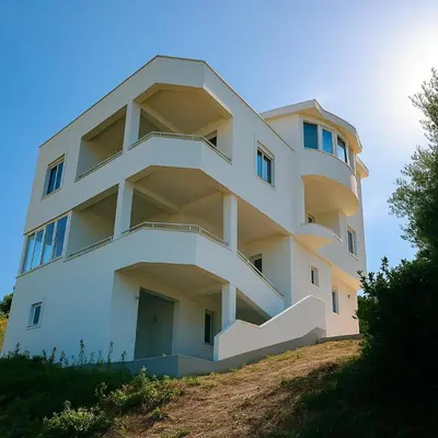 a white building on top of a hill at Apartments Lejla in Dobra Voda