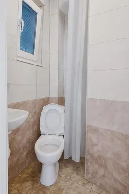a bathroom with a toilet and a sink at Apartments Lejla in Dobra Voda