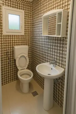 a bathroom with a toilet and a sink at Apartments Lejla in Dobra Voda
