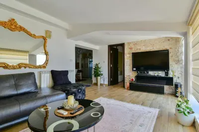 a living room with a couch and a table at Apartments Kentera LUX in Sveti Stefan