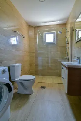 a bathroom with a toilet and a sink and a shower at Apartments Kentera LUX in Sveti Stefan