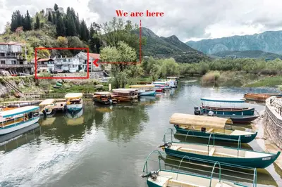 a group of boats are docked in a river at Apartments FLORA and boat cruising in Virpazar