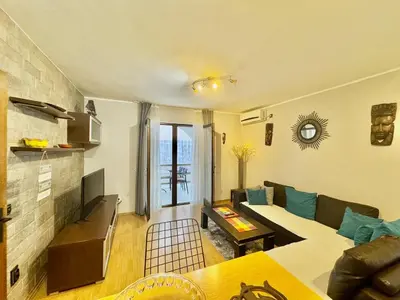 a living room with a couch and a table at Apartments HMD in Budva